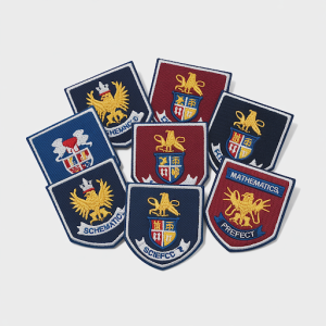 An array of school badges and patches designed for UK school uniform